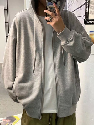 Gray casual zip-up hoodie with drawstring hood and pockets, worn over a white t-shirt.