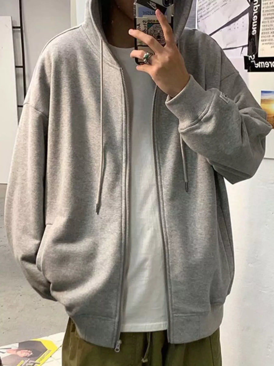 Gray casual zip-up hoodie with drawstring hood and pockets, worn over a white t-shirt.