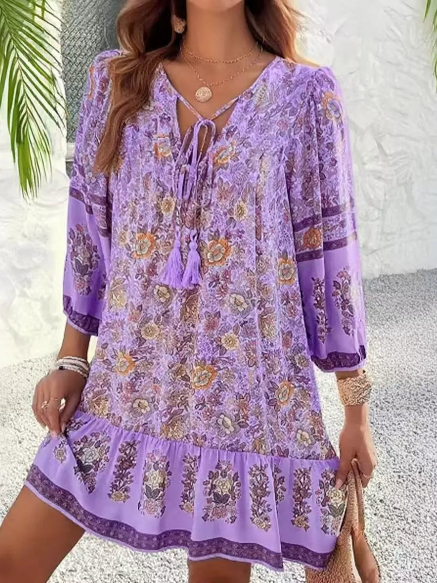 Purple floral print mini dress with tassel tie neckline and ruffled hem