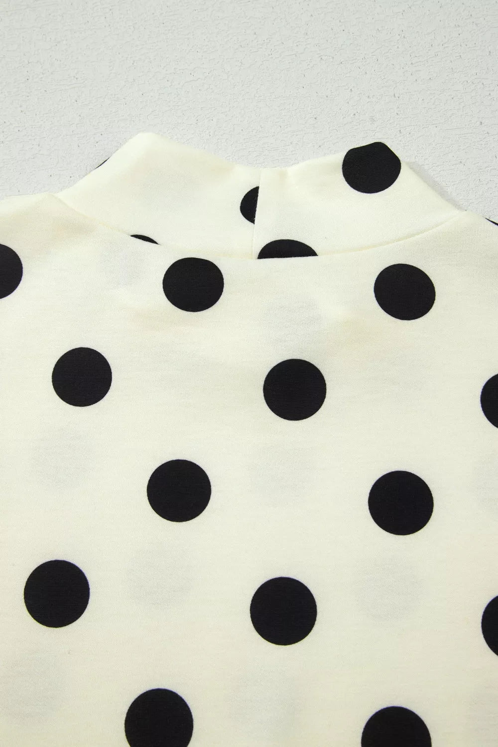 Cream polka dot mock neck top