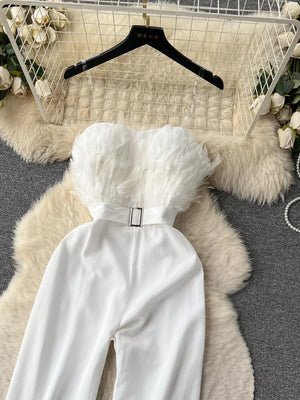 White strapless wide-leg jumpsuit with feather trim and belted waist