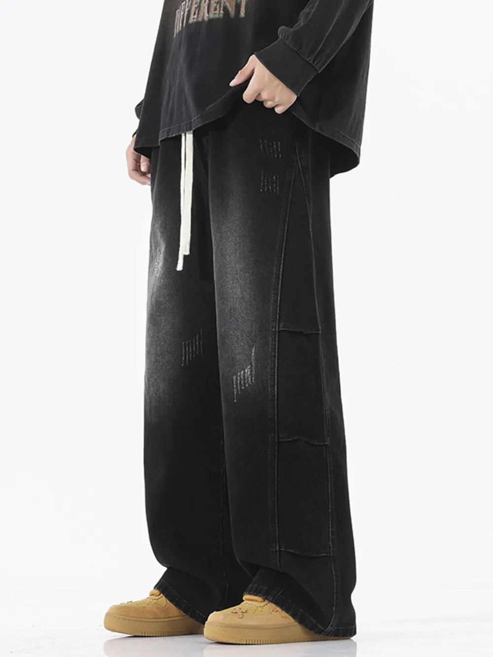 Oversized black vintage wash wide leg jeans with distressed details and drawstring waist.