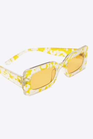 Rectangular frame sunglasses in Butter Yellow with a swirl print and amber lenses.