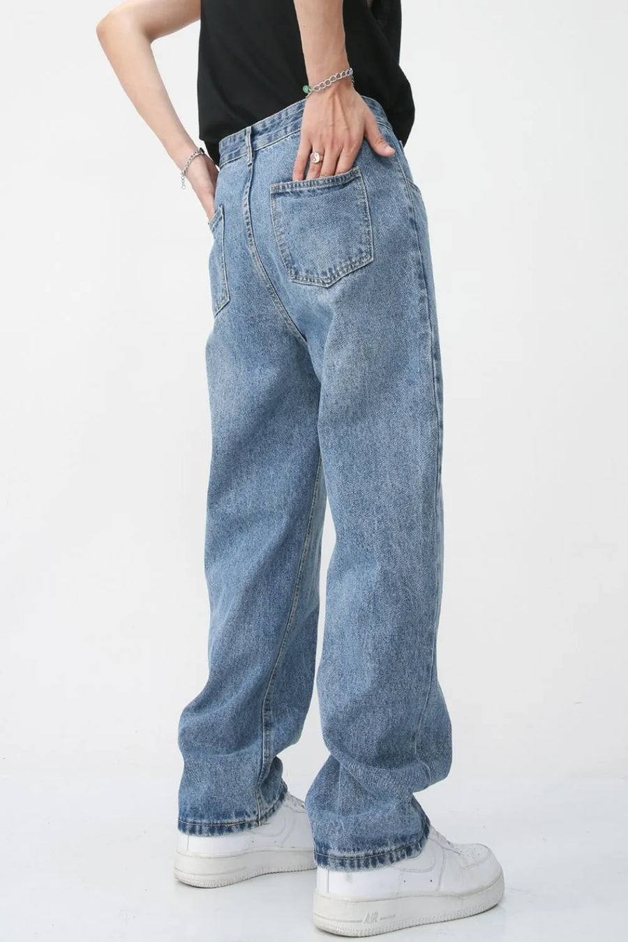 Light wash denim jeans with vertical seam detail and relaxed fit.