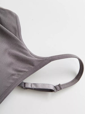 Dark gray cami pajama top detail showing adjustable strap and neckline.