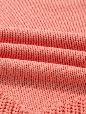 Burnt coral knit sweater with detailed texture and subtle open knit pattern.