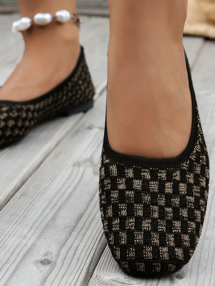 Black woven knit square-toe flats with a checkered pattern.