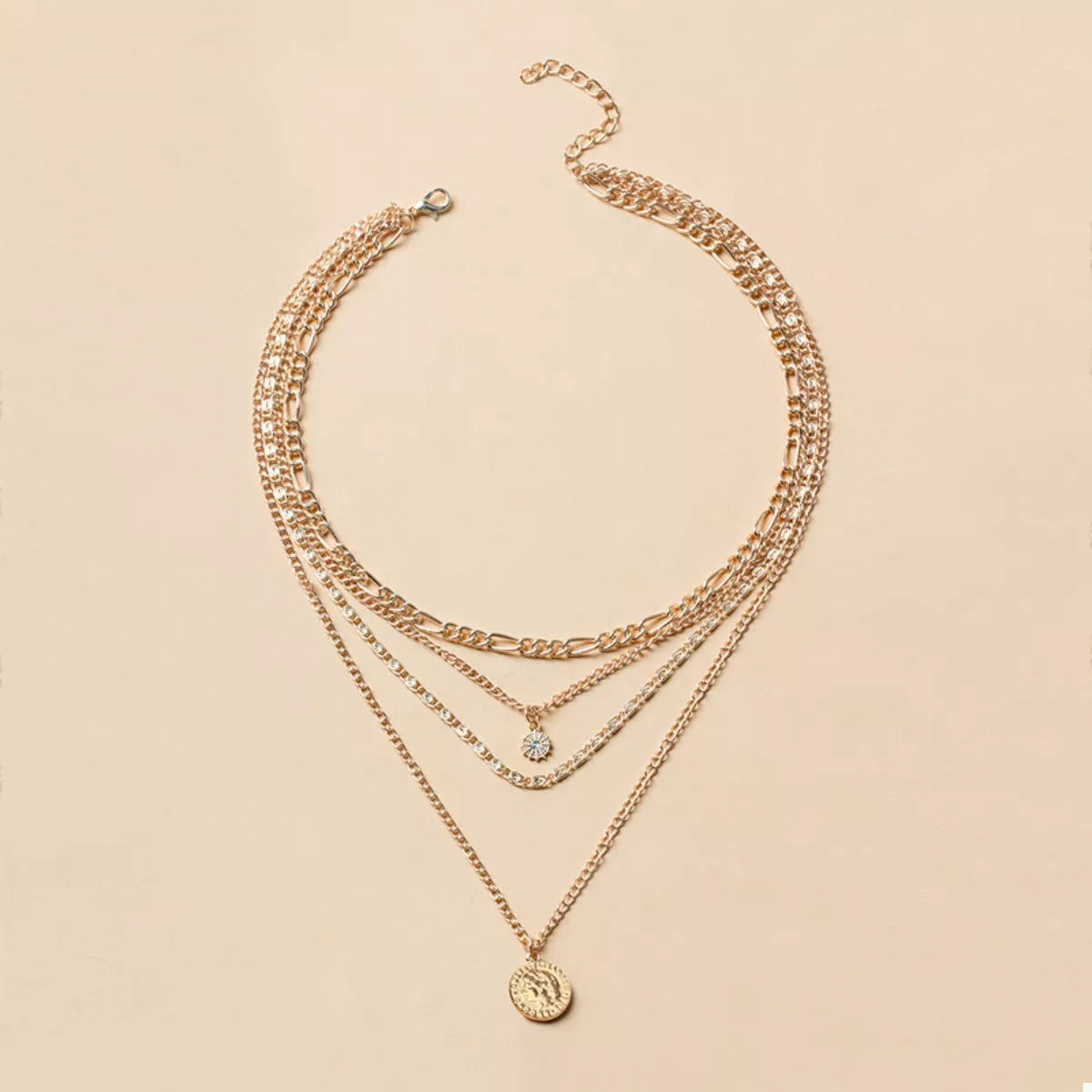 Gold layered coin pendant necklace with a clear stone accent