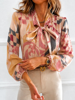 beige blouse featuring bow-tie neck and geometric