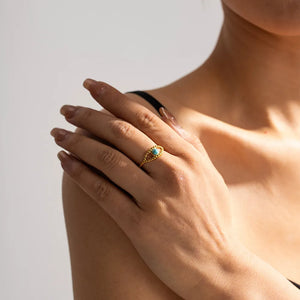 turquoise ring featuring eye design and geometric