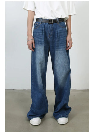 Pleated-front wide-leg denim trousers in peacock blue with a relaxed fit.