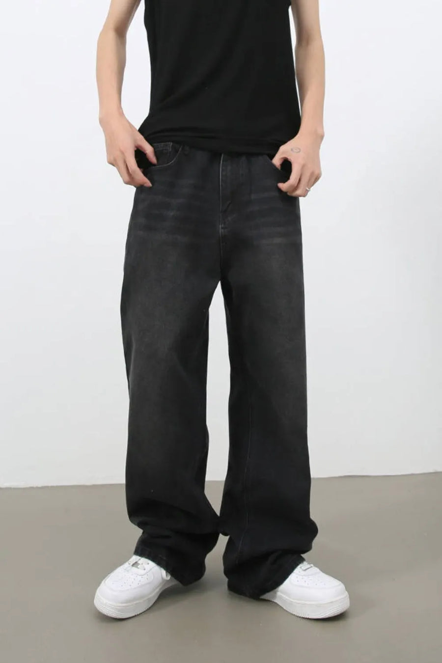 Black wide leg denim jeans with a relaxed fit and faded wash.