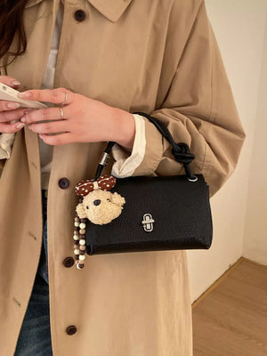 crossbody bag in black featuring structured and boxy fit