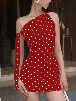 Red polka dot mini dress with asymmetrical neckline and single cold shoulder sleeve with bow detail.