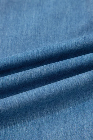 Chambray maternity jeans in a light wash denim with a wide-leg cut and ruffled hem detail.