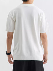 Men's white ribbed knit polo shirt with short sleeves and a classic collar.