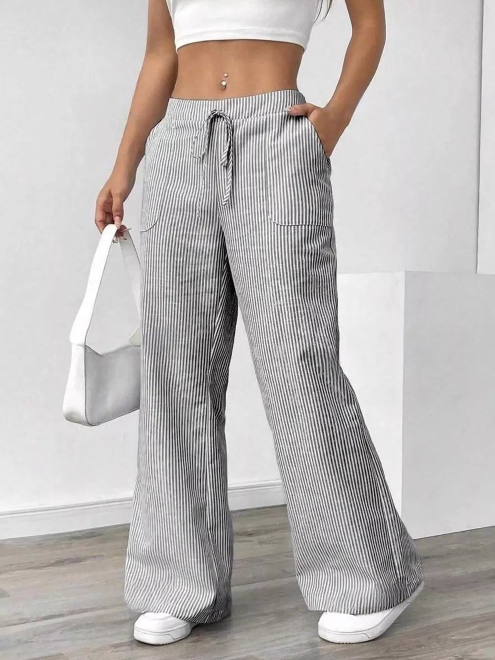 wide-leg pants in white featuring drawstring waist and flared fit