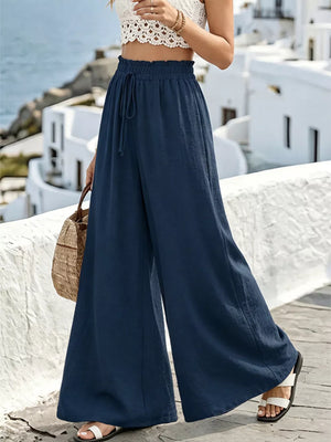 Navy linen wide-leg pants with drawstring waist and ruffled detail