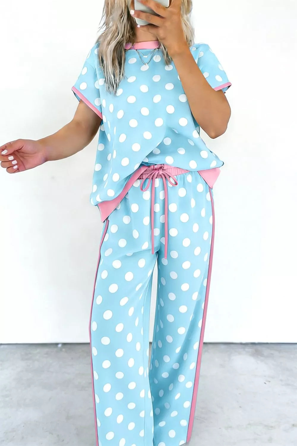 Polka dot loungewear set with contrast trim, drawstring waist, and wide leg pants.