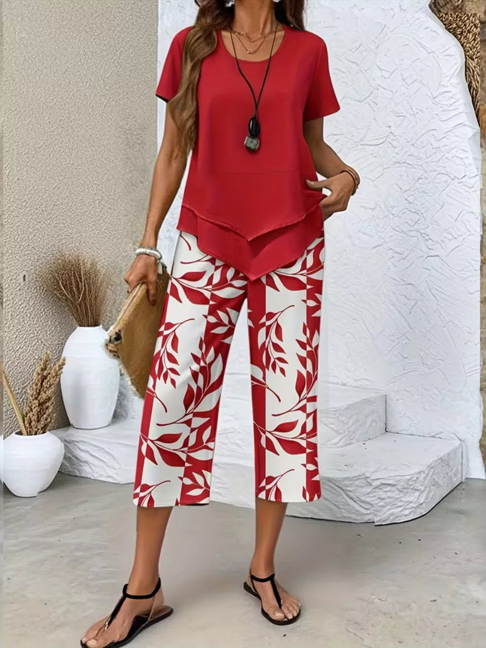Red layered short sleeve top with red and white leaf print capri pants.