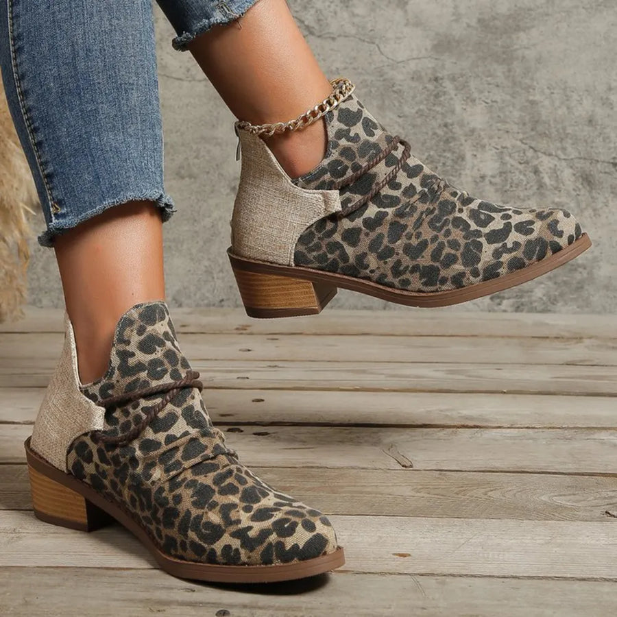 Leopard print ankle boots with cutout sides and chain detail