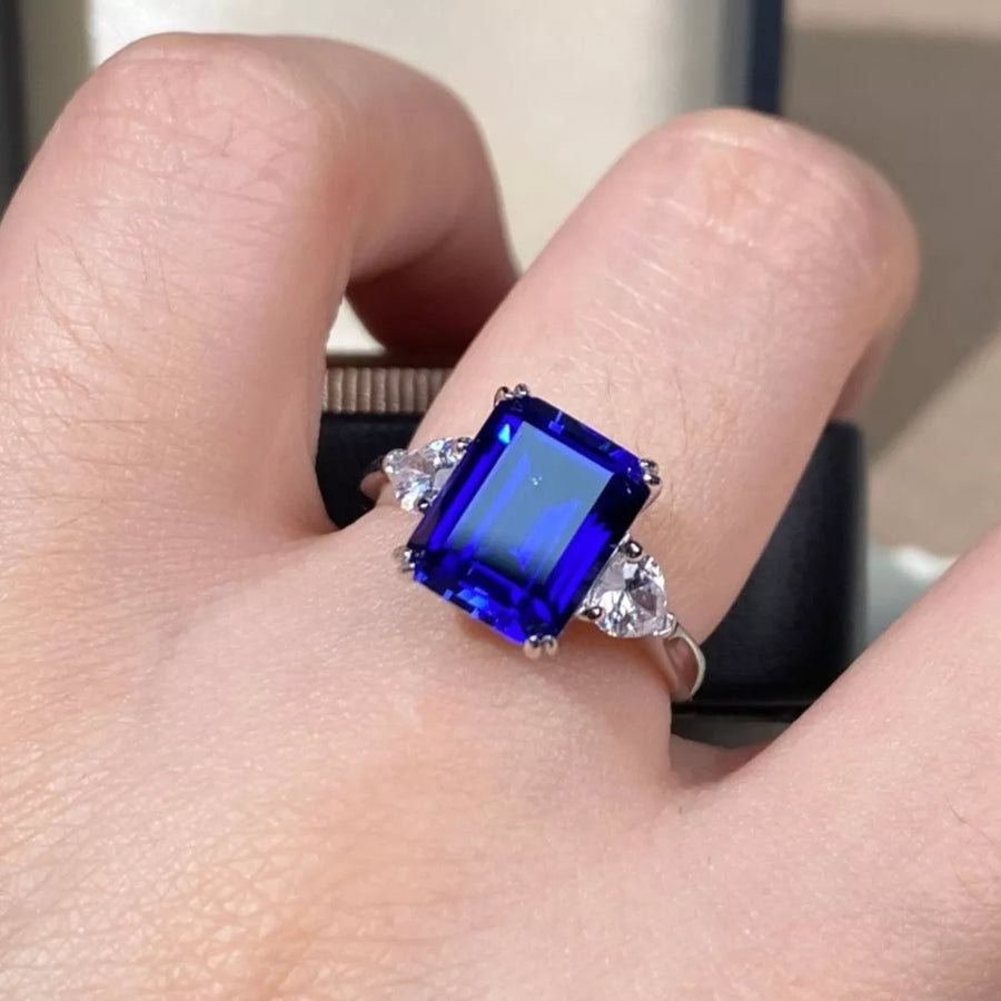 silver ring featuring three-stone setting and geometric