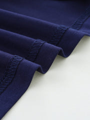 Navy blue cotton t-shirt detail showing reinforced stitching on hem and sleeves.