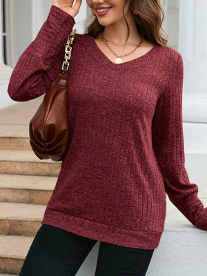 Red textured V-neck knit long-sleeve top with ribbed details.