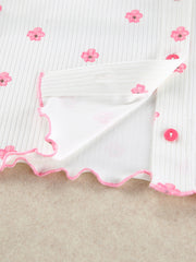 White knit lounge set with pink floral print, button front, and frill trim.