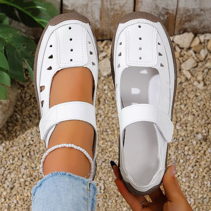 White round toe platform flats with cutouts and adjustable strap.