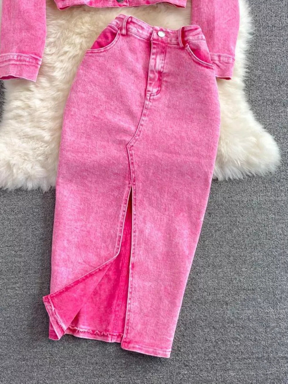Pink denim two-piece set with button-down cropped jacket and midi skirt with front slit