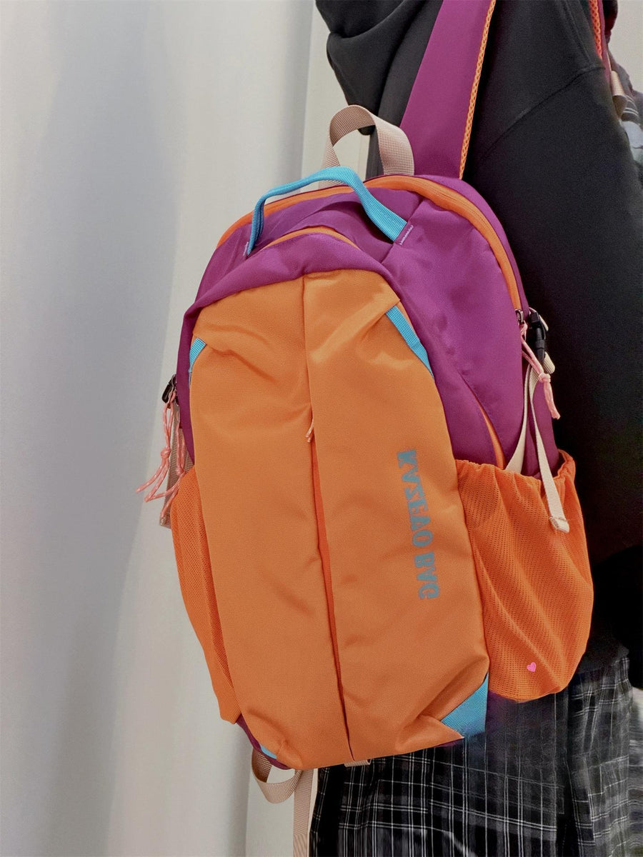 Medium nylon backpack in purple and orange with blue accents and mesh side pockets.