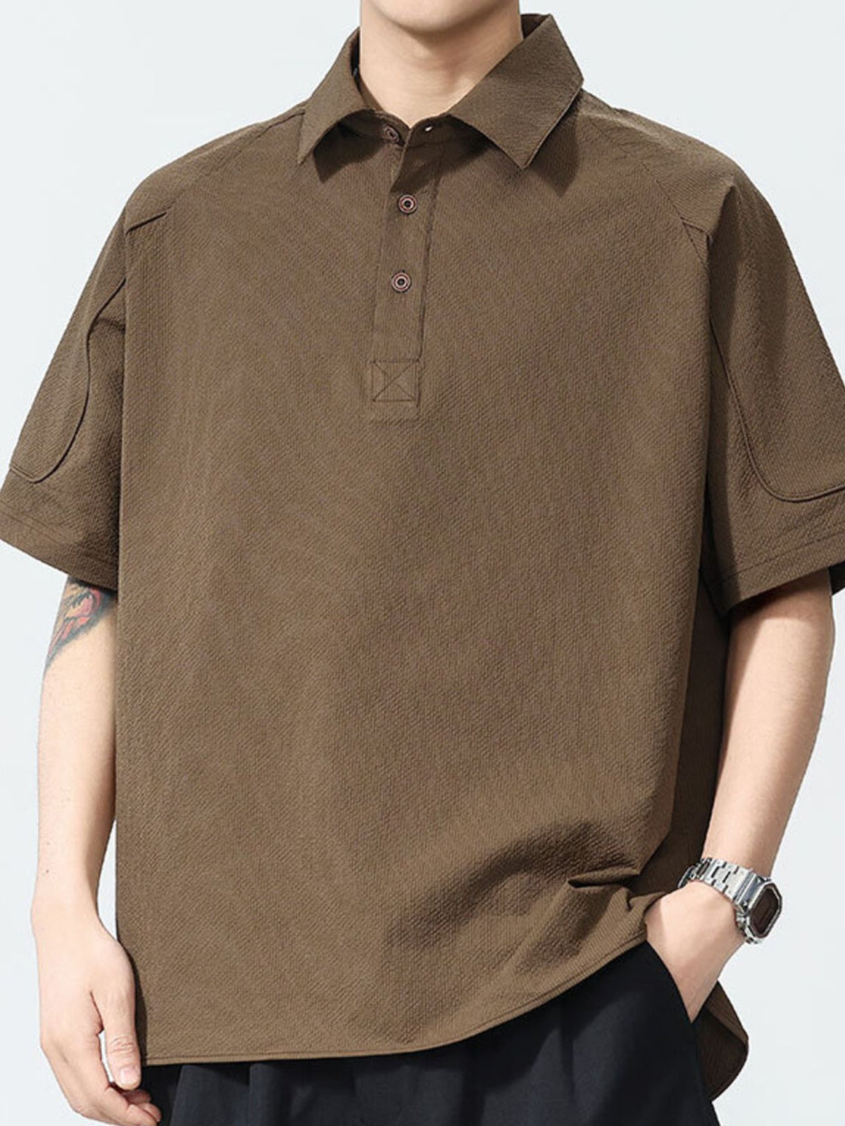 Brown textured short sleeve polo shirt with button placket and classic collar.