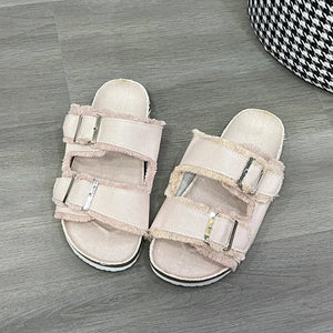 Denim frayed-edge buckle slides in blush pink with adjustable straps.