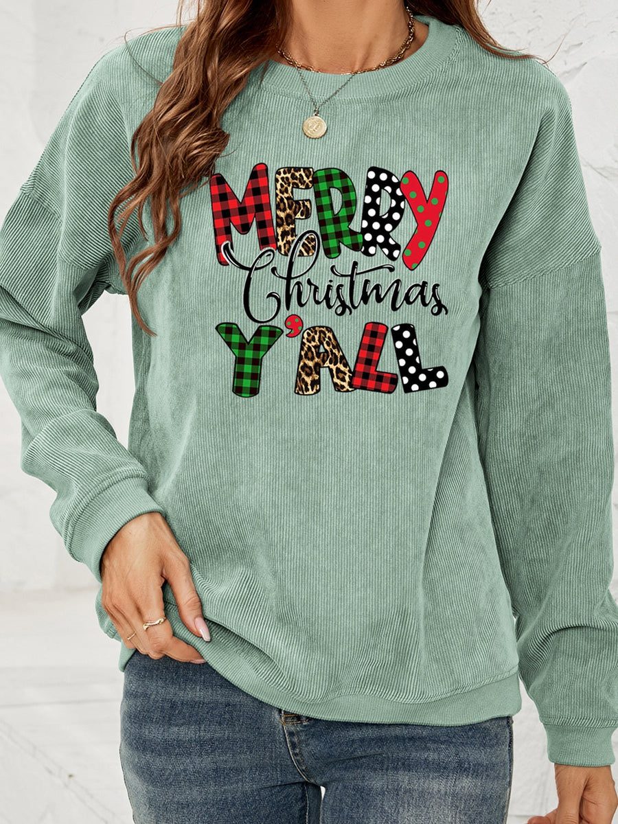 Sage corduroy sweatshirt with Merry Christmas Y'all graphic in buffalo plaid, leopard, and polka dot patterns.