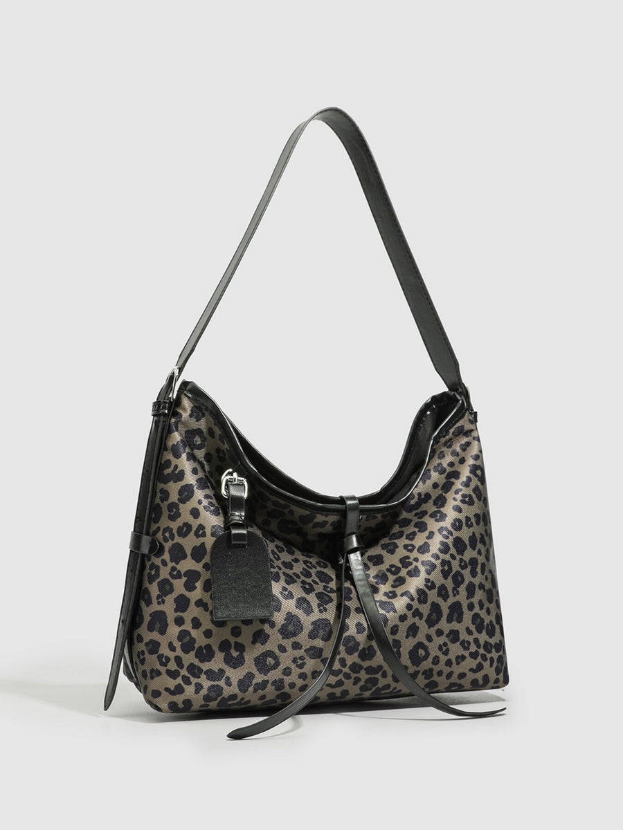 black shoulder bag featuring shoulder strap and leopard-print