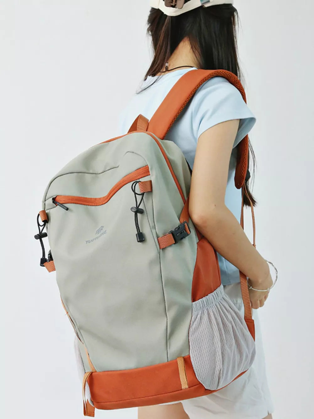 Large grey nylon backpack with orange accents and mesh side pockets.