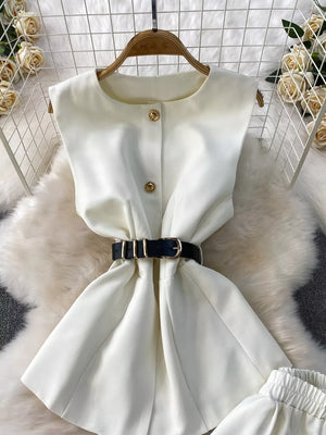 White belted sleeveless two-piece set with gold button detail and pockets