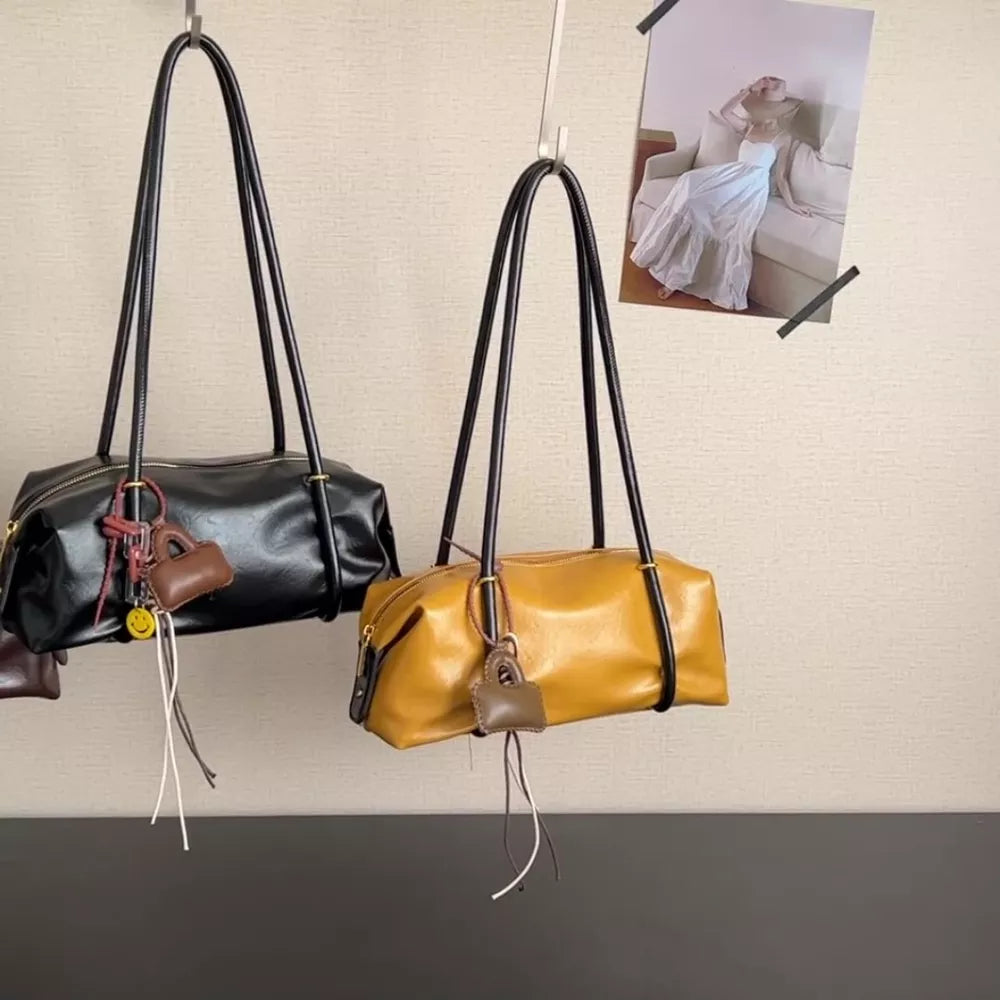 Chic pu leather shoulder bag in yellow with charm and black with charm.