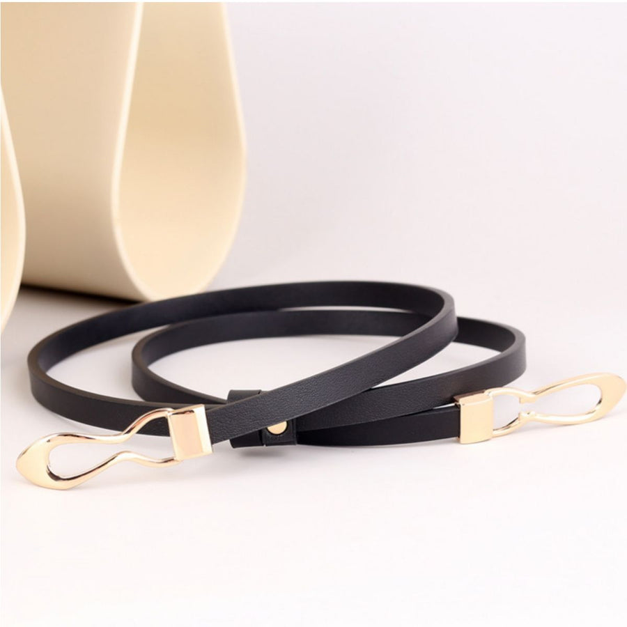 Black leather belt with gold interlocking buckle detail