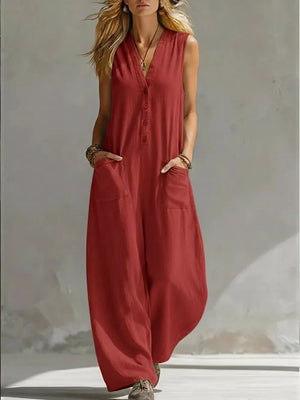 Red linen blend jumpsuit with V-neck, button front, sleeveless design, and wide legs.