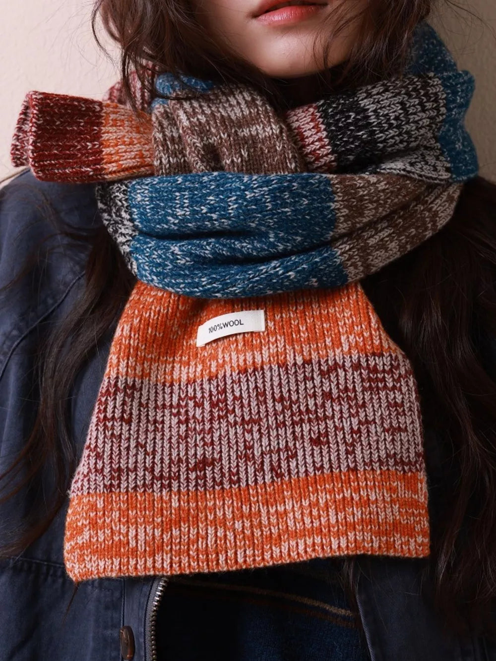 Textured wool scarf with color block pattern in orange, blue, brown, and red.