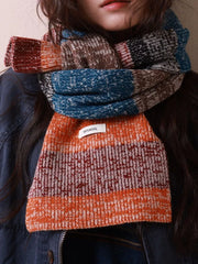 Textured wool scarf with color block pattern in orange, blue, brown, and red.