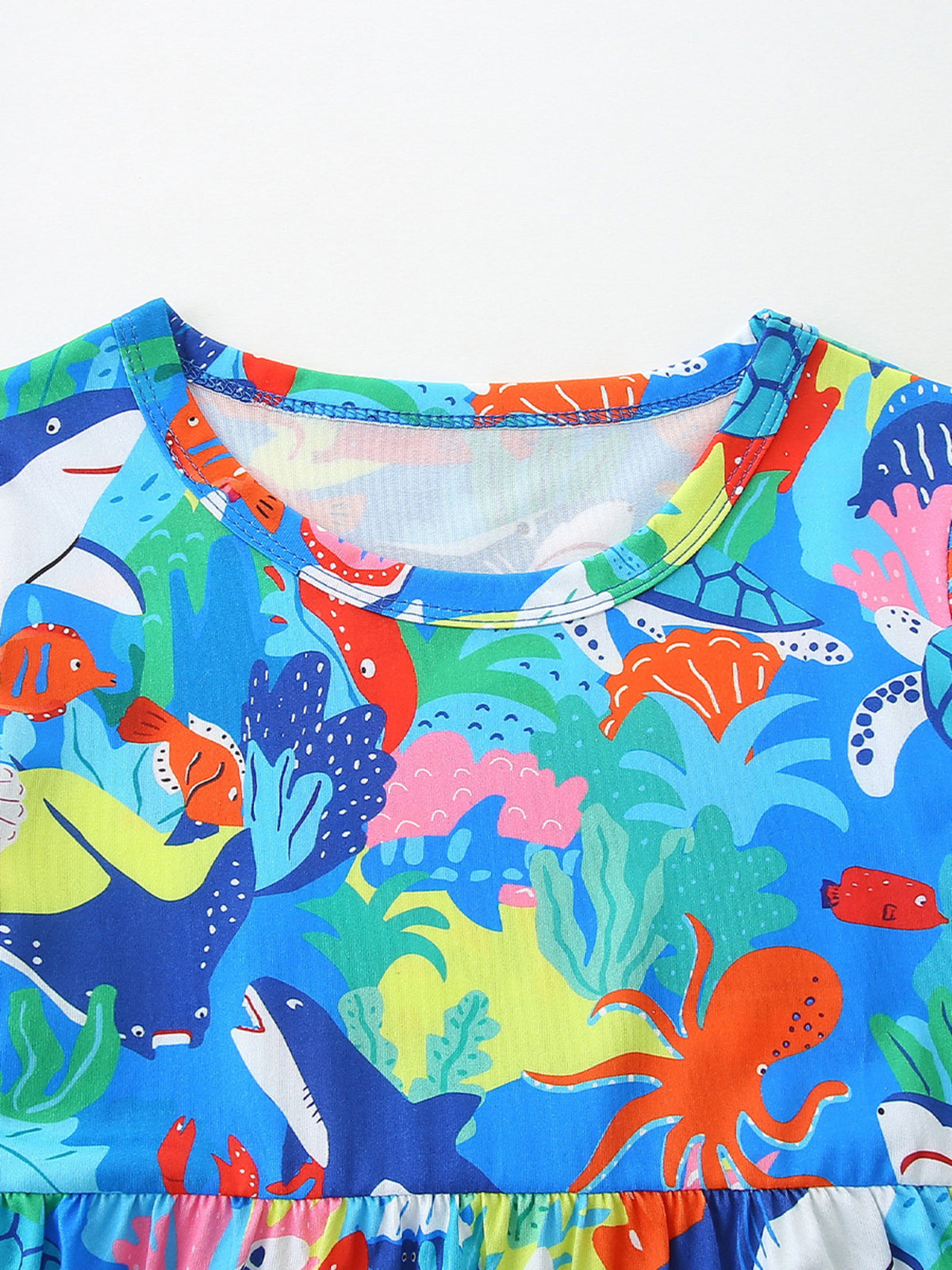 Toddler dress with colorful ocean print, featuring sharks, octopuses, and coral.