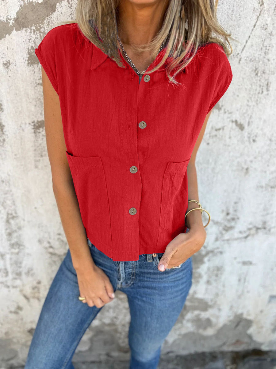 Scarlet button-down cap sleeve shirt with two chest pockets and button front.