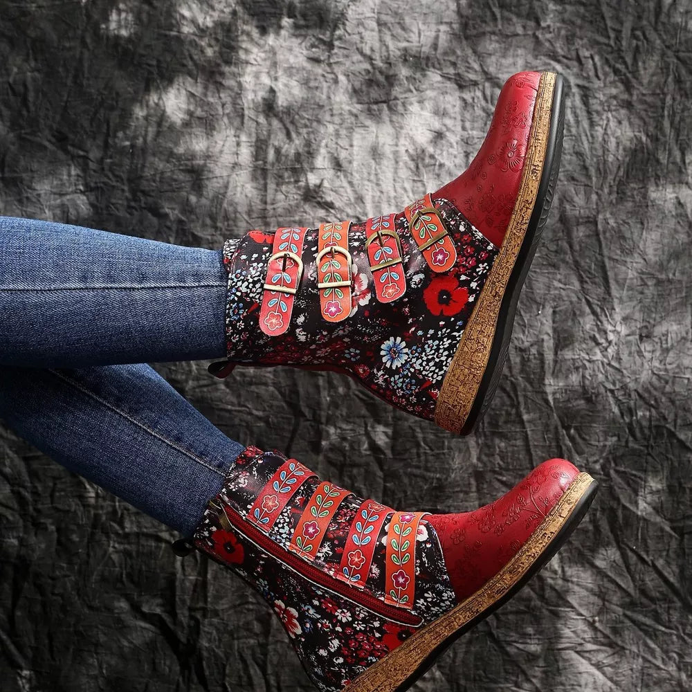 Red and blue floral embroidered suede ankle boots with decorative buckle straps and side zipper.