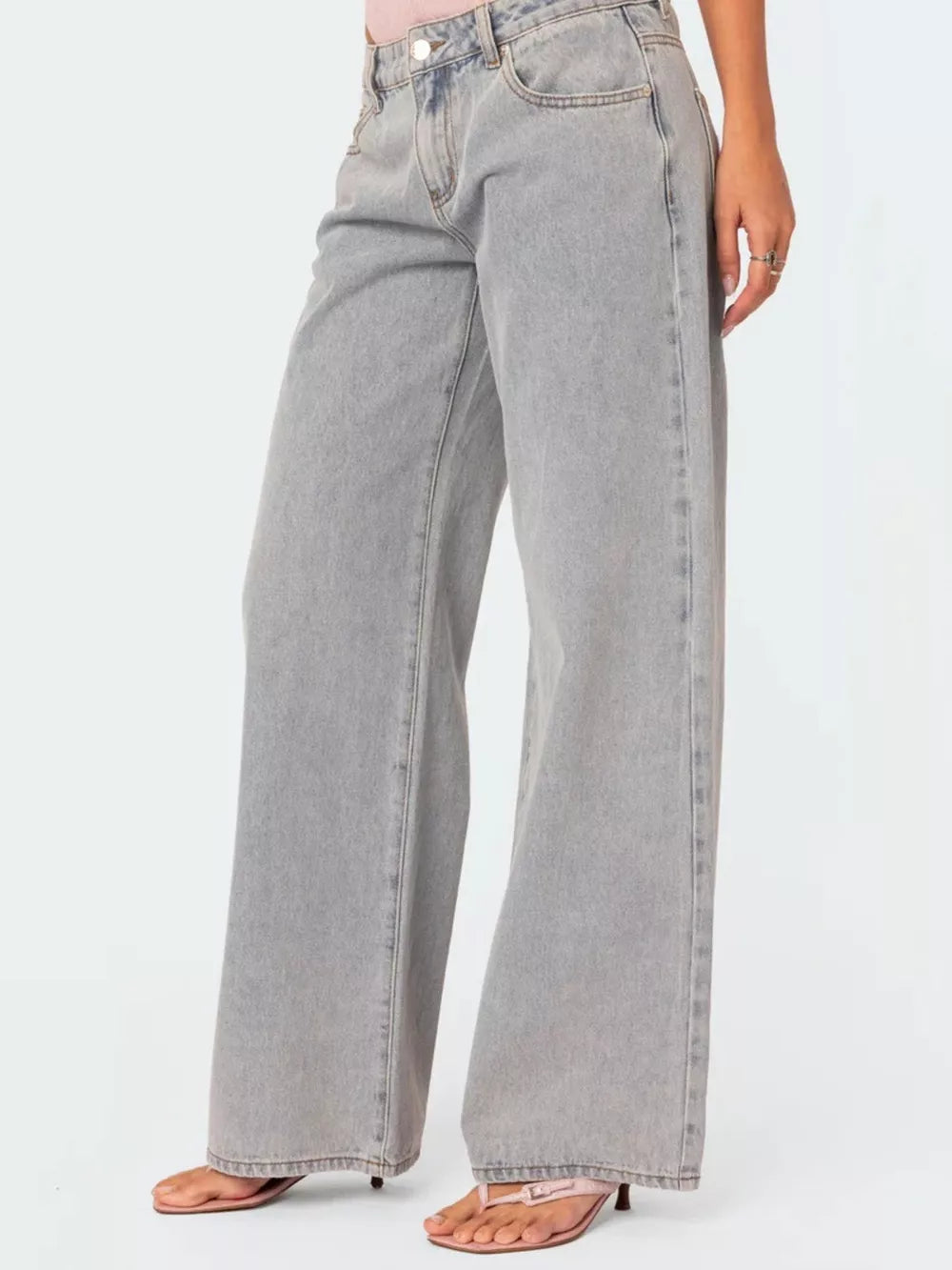 High-waisted relaxed fit grey cotton blend jeans with button closure.