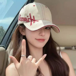 Ivory baseball cap with red embroidery and trim, cotton material