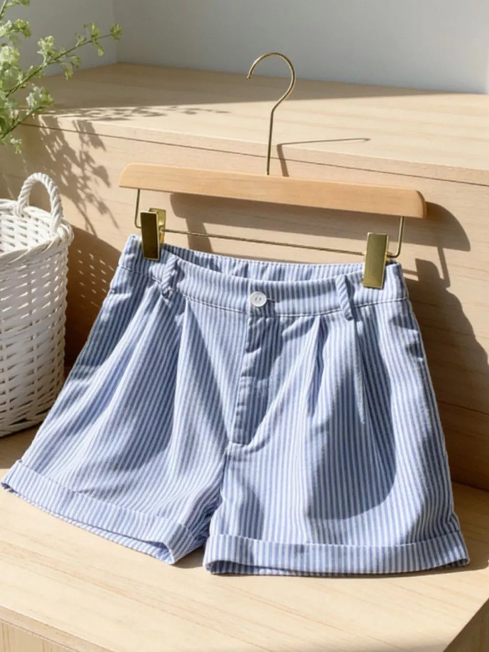 Blue and white striped chino shorts with cuffed hems and button closure.