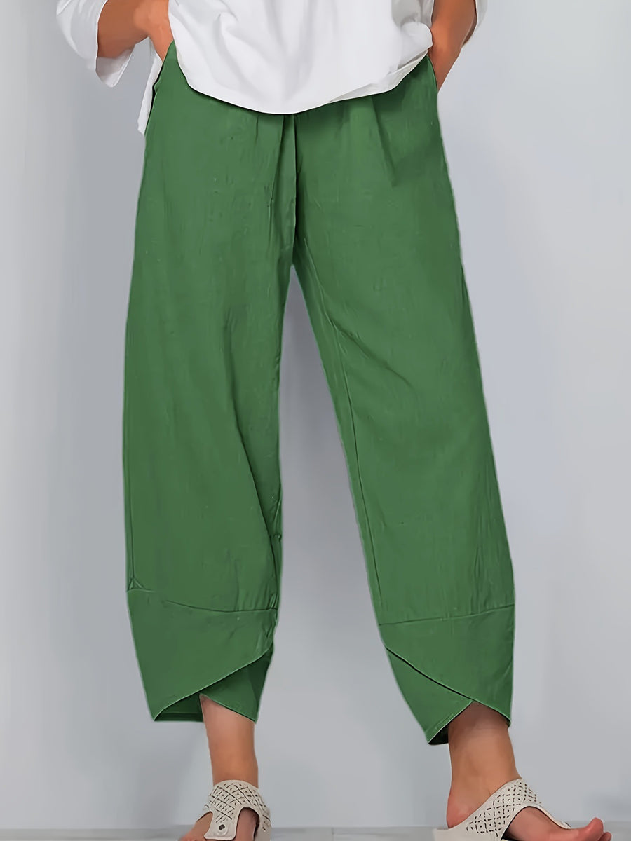 Relaxed fit army green wide-leg pants with asymmetrical hem detail and pockets.